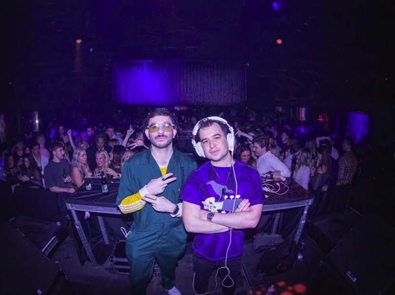 Cakebatter performing together in a packed nightclub